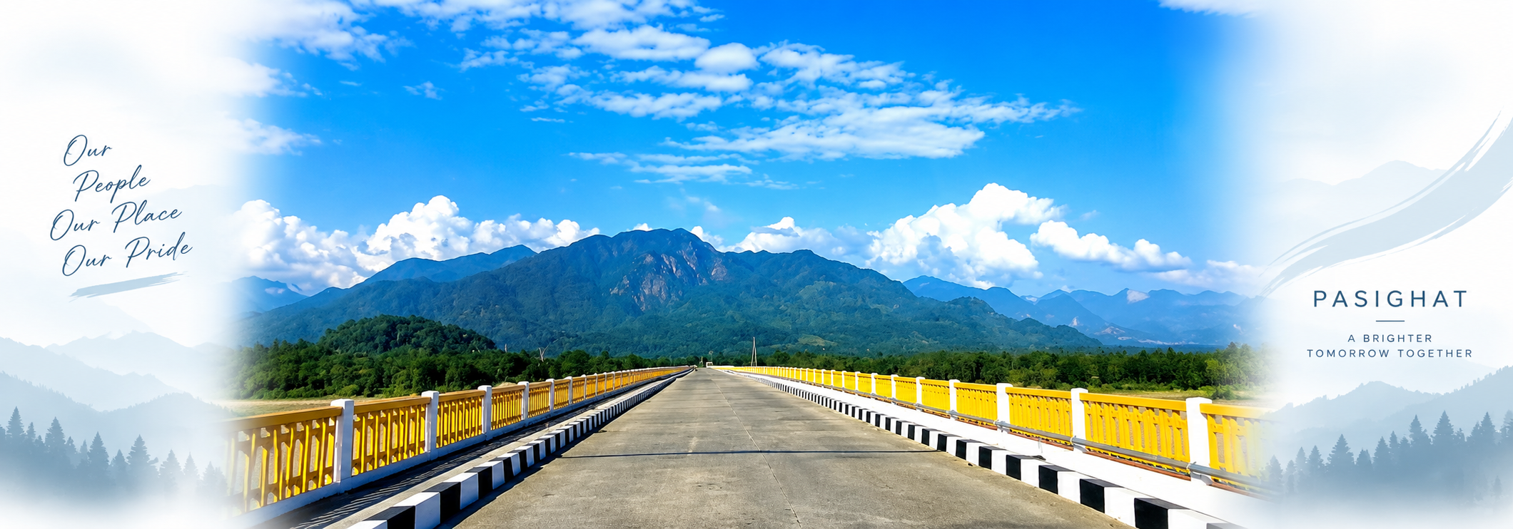 A concrete road bridge with yellow-and-white railings running straight toward forested blue mountains under a bright cloud-streaked sky at Pasighat