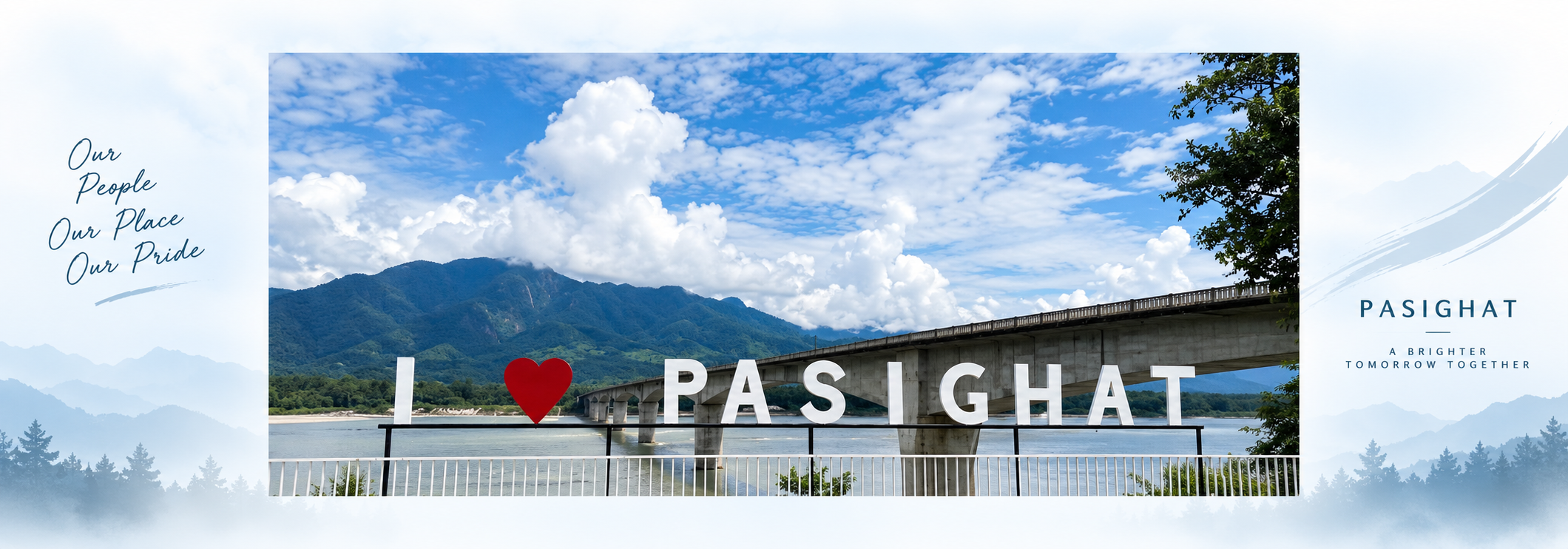 Large white "I love Pasighat" letters with a red heart by the riverfront, with the long Siang river bridge and mountains under a cloudy blue sky behind